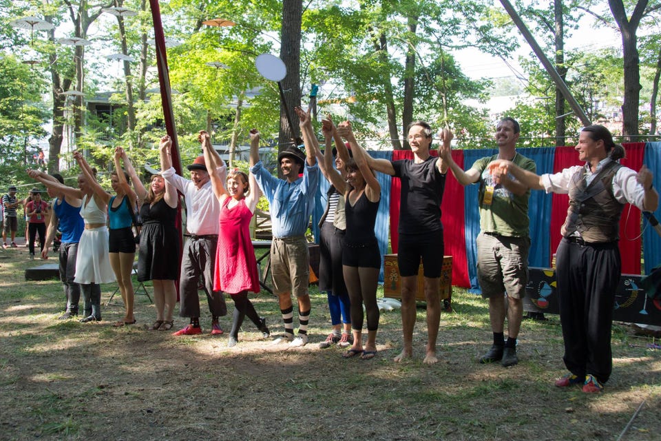 line of performers at outdoor festival taking a bow