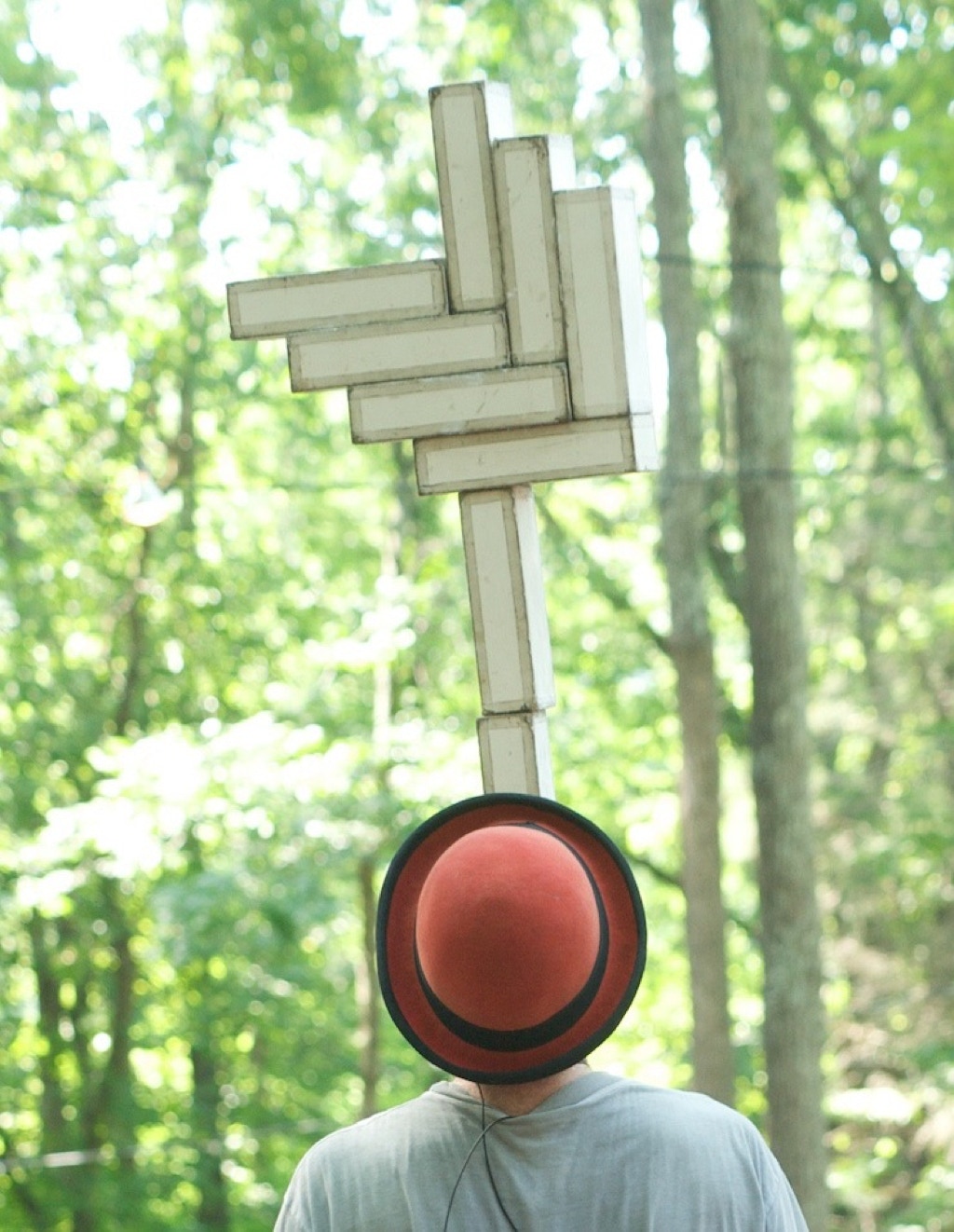 dave balancing a stack of cigar boxes in the woods