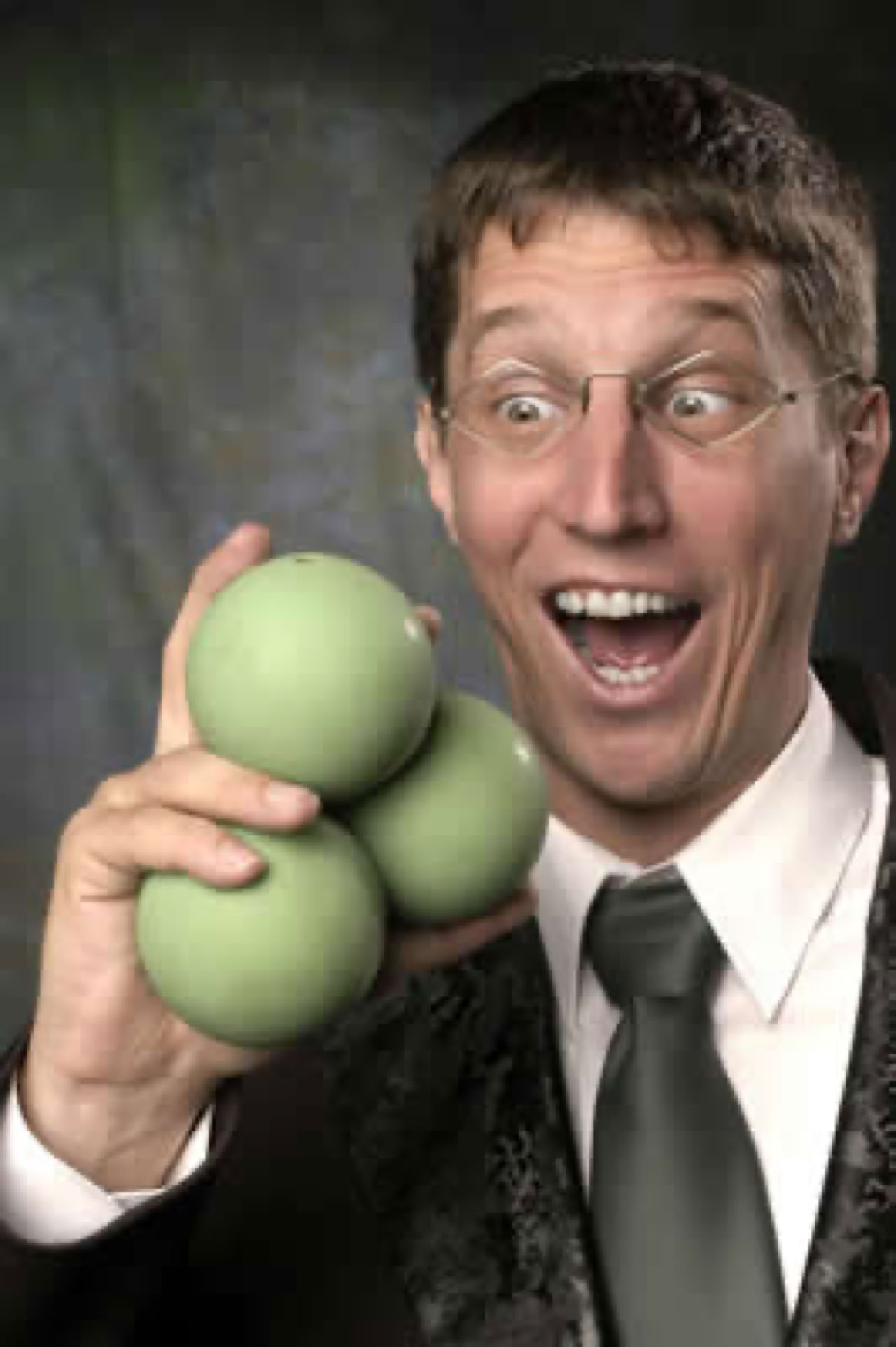 keith holding 3 green juggling balls