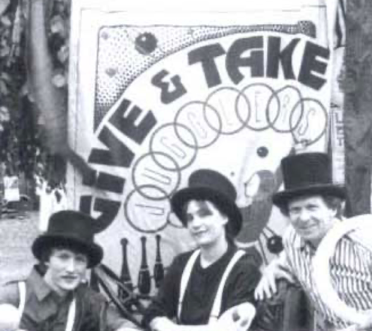 3 jugglers posing in front of a banner