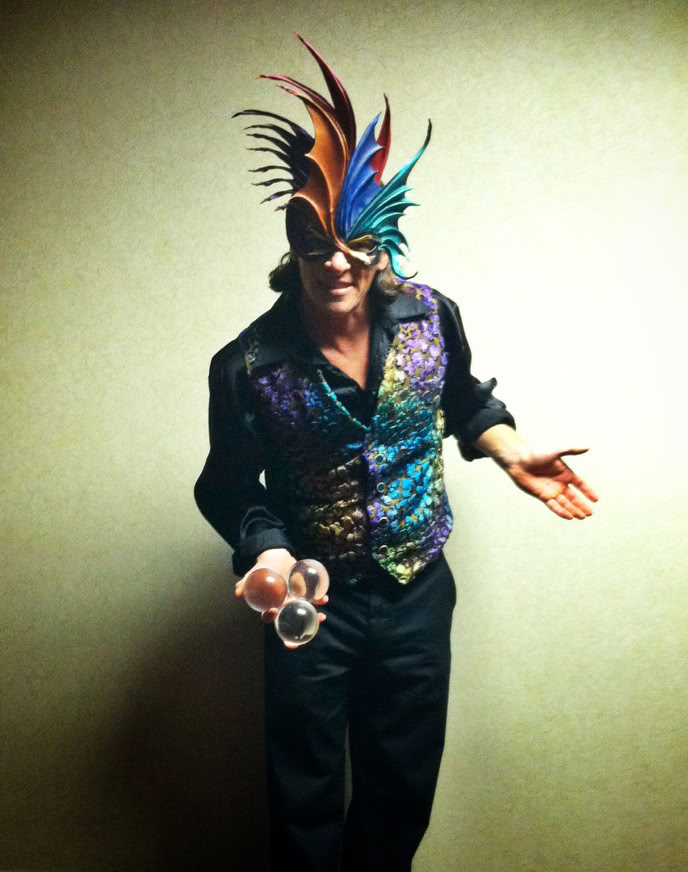 costumed mardi gras juggler with glass balls