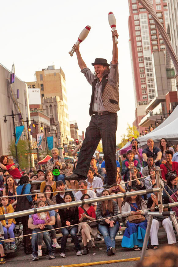 juggler on a tight wire in a street fair
