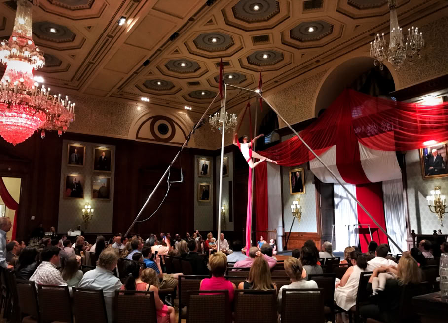 ornate ballroom circus aerialist performing